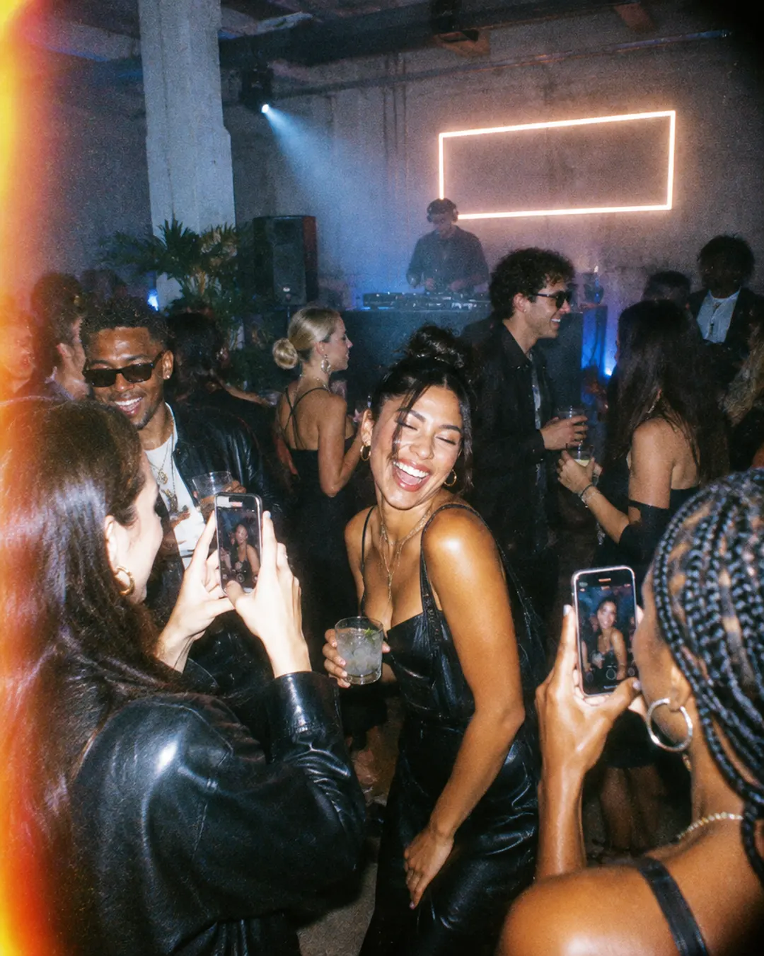 Guests taking photos with their phones at a brand event