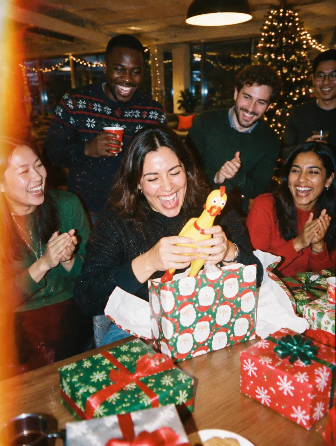 Coworkers laughing at a holiday gift swap
