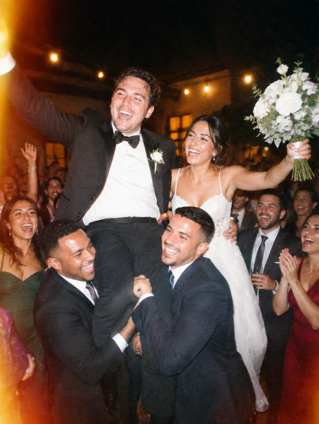 Groom lifted on his friends' shoulders